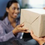businesswoman receiving a package in an office